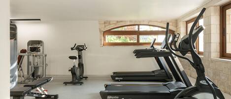 A gym with treadmills, a stationary bike, and weight machines.