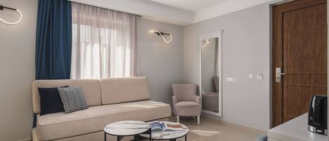 A modern living room with a sofa, a small round table, a chair, and a wooden door.