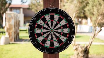 A dartboard mounted on a wooden post.