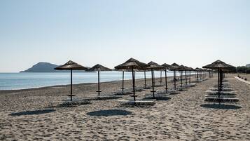 On the beach, sun-loungers, beach umbrellas, beach towels