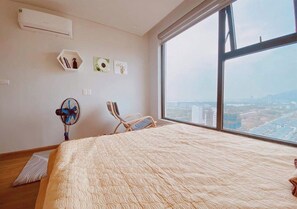 Enjoy a restful night's sleep in this spacious room with a large bed and city view.
