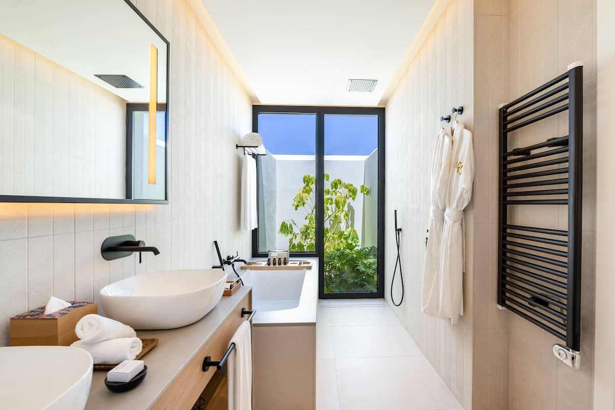 separate bathtub and shower, rainfall showerhead, designer toiletries