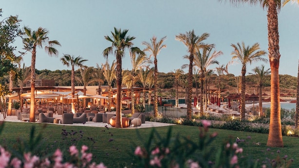 A resort with outdoor seating areas, palm trees, and a pool. - SO/ Sotogrande Spa and Golf Resort Hotel Costa del Sol (San Roque)