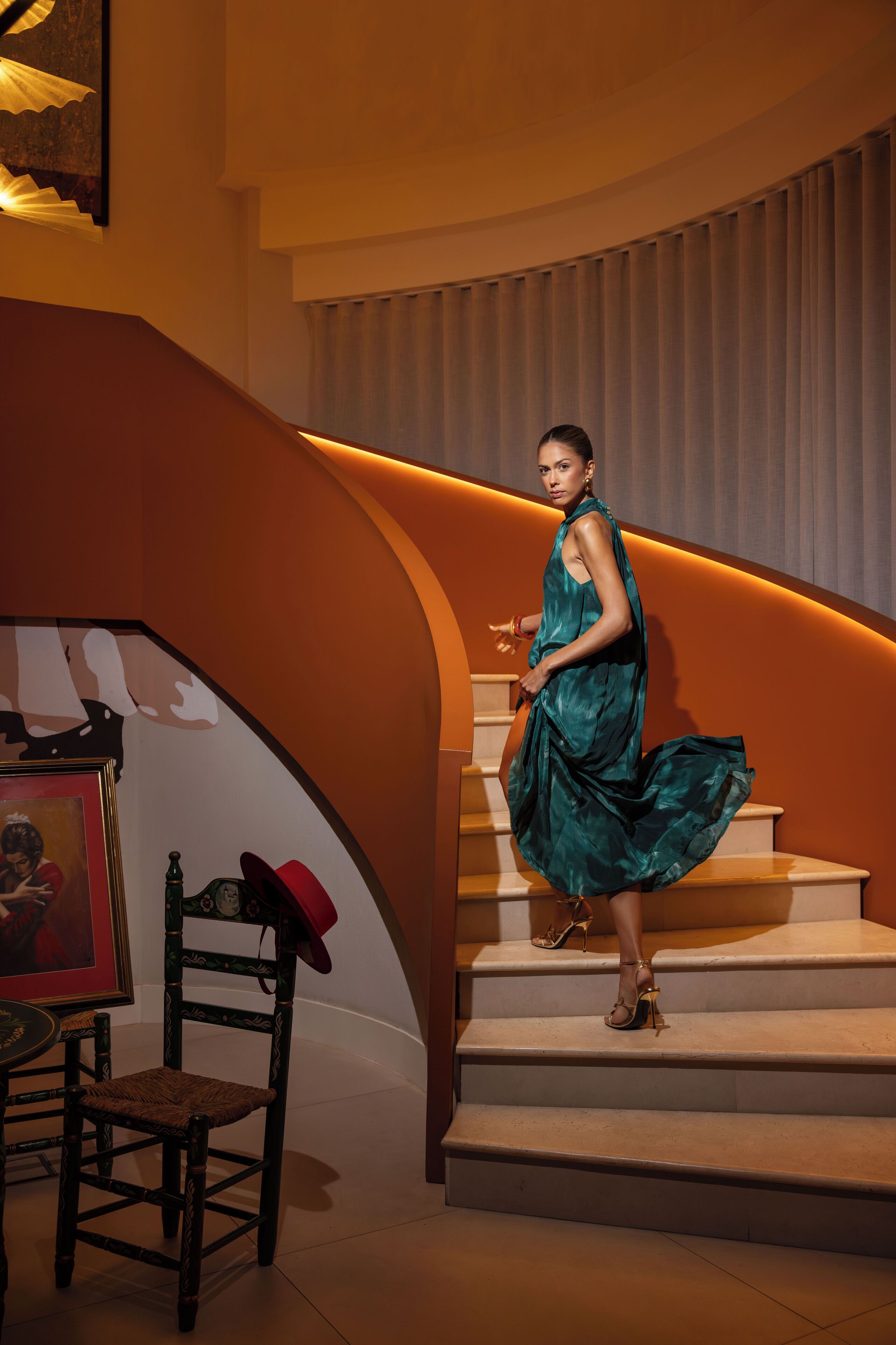 A staircase with a woman in a dress.