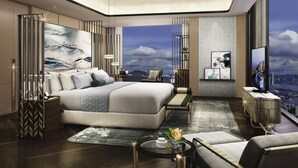 A modern hotel room with a large bed, a city view, a desk, and a TV. - Sofitel Hangzhou Yingguan Hotel (Hangzhou)