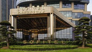 A modern hotel entrance with a glass facade and a sign reading "SOFITEL". - Sofitel Hangzhou Yingguan Hotel (Hangzhou)