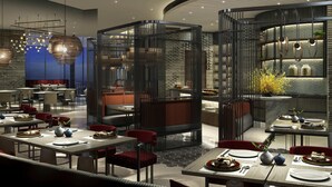 A modern restaurant with high tables and chairs, a brick wall, and a view of the cityscape. - Sofitel Hangzhou Yingguan Hotel (Hangzhou)