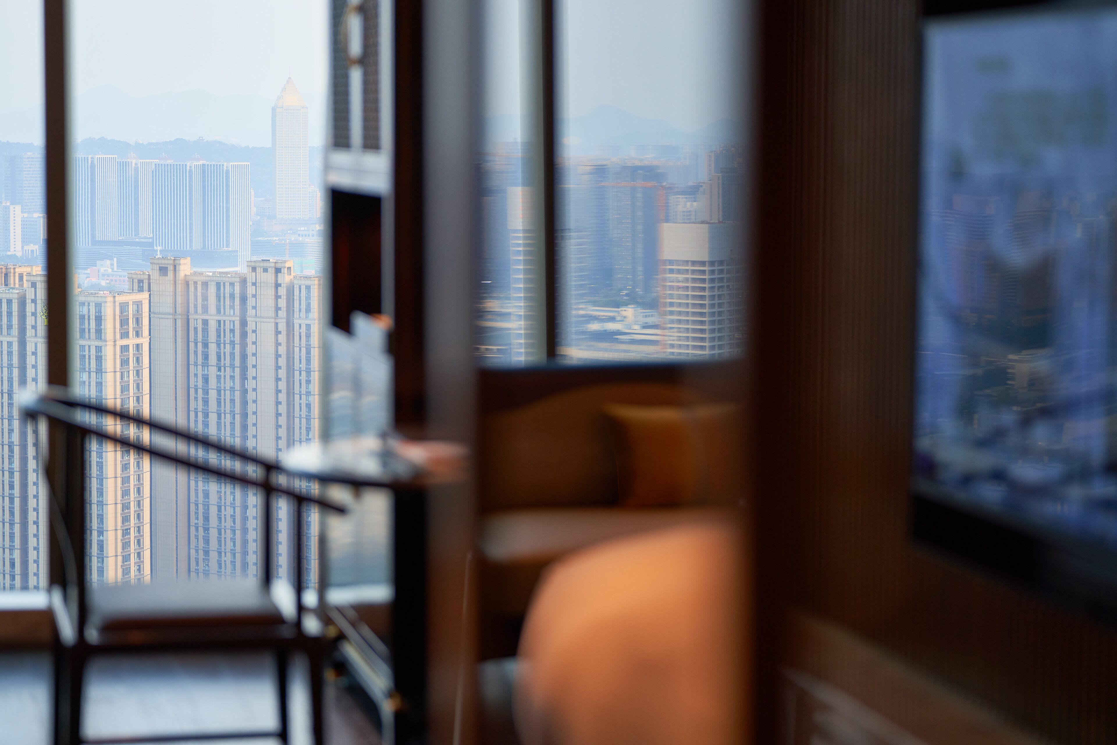 A modern interior with a view of high-rise buildings.
