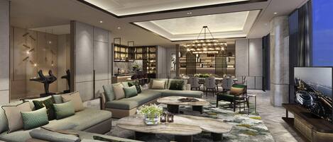 A modern living room with a sectional sofa, a coffee table, and a dining area with chairs and a table.