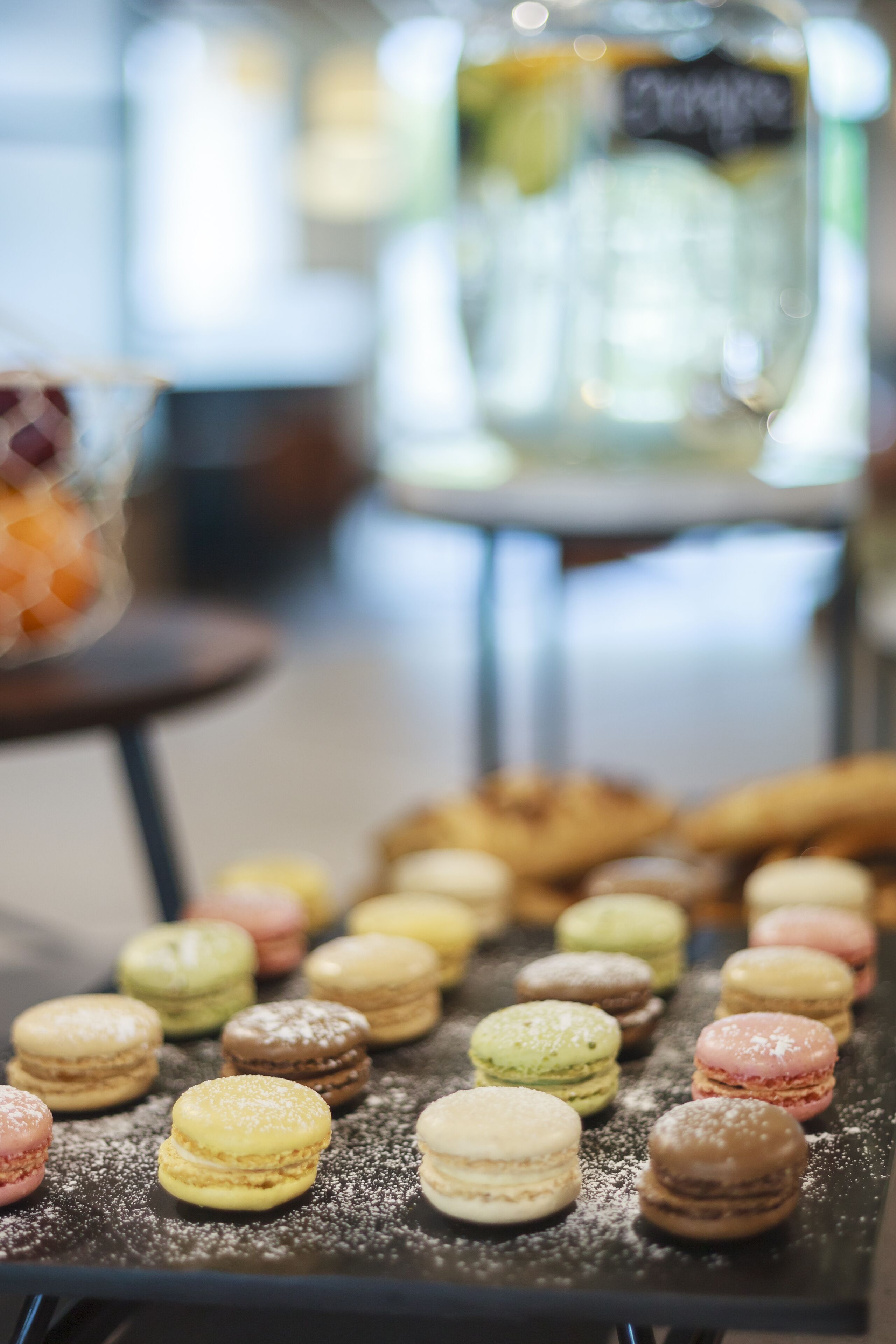 A variety of colorful macarons arranged on a tray.
