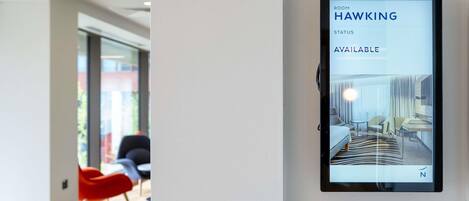 A digital room booking display with 'ROOM WALKING' and 'HAWKING' visible, indicating a room is available.