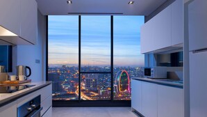 A modern kitchen with a city view, large windows, and contemporary appliances. - Mövenpick Living Istanbul West (Istanbul)