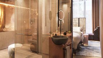 Enjoy a comfortable stay in this stylish room with a large mirror, spacious shower, and a bed with an outdoor view.