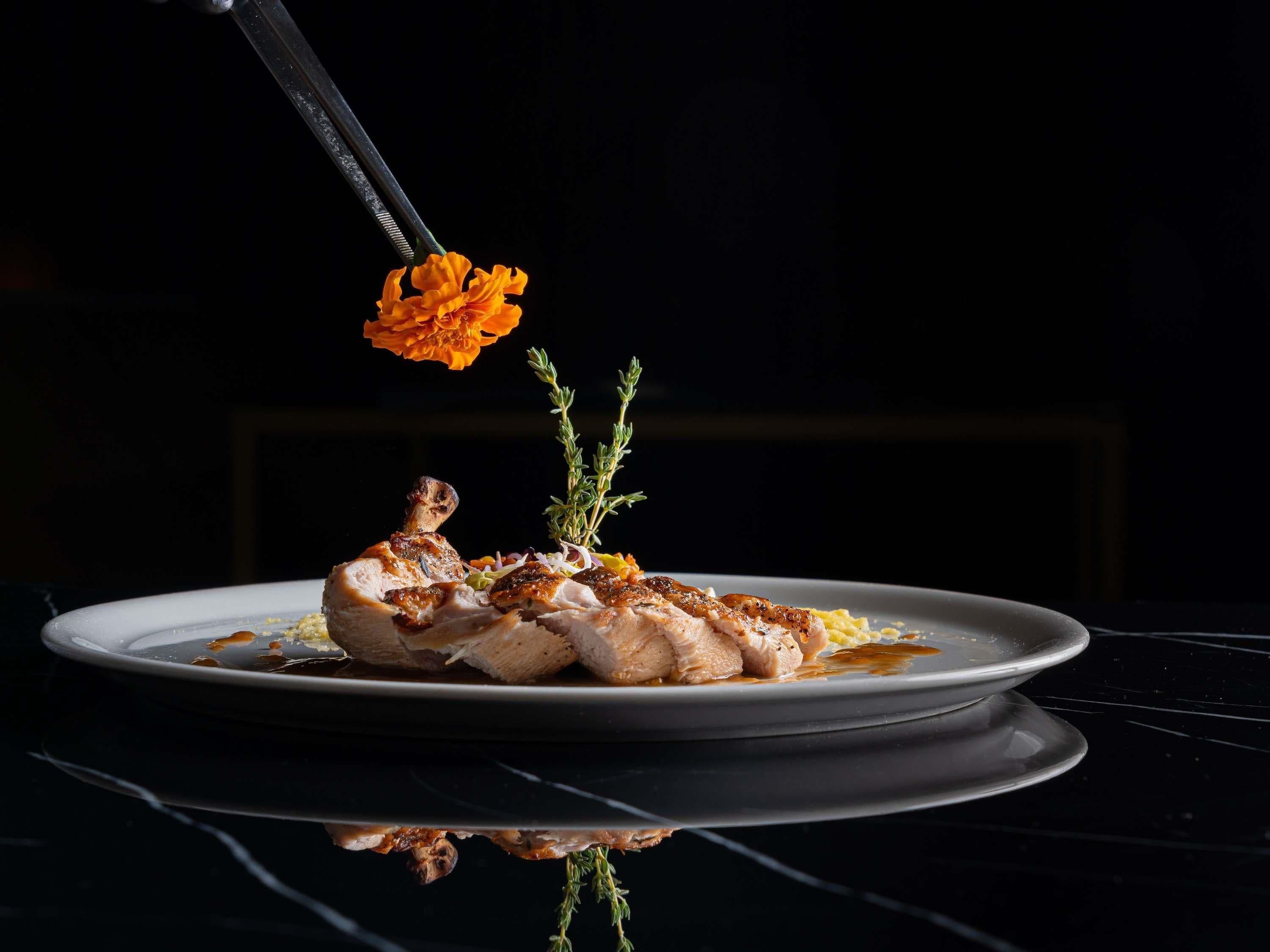 A plate of food with a flower garnish.