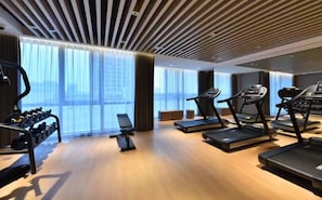 A modern gym with treadmills, a rowing machine, and dumbbells. - Novotel Shanghai Chuansha (Shanghai)