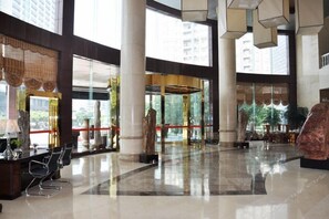 A spacious lobby with high ceilings, large windows, and a polished floor. - Bliss Hotel (Nanning)