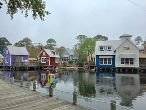A waterfront area with buildings, a dock, and a calm body of water. - Stunning 30A Home-Pool, Bikes, Golf Cart, Pickleball, AC, 5 mins to the Beach (Santa Rosa Beach)