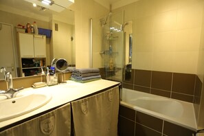 Bathtub, hair dryer, towels, soap