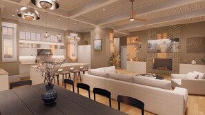 Un intérieur moderne comprenant un coin repas, des canapés, une cheminée et une cuisine.