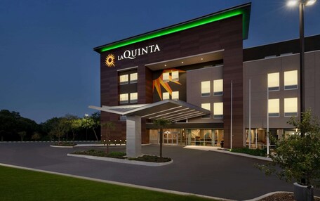 A modern hotel with a prominent sign reading "LA QUINTA".