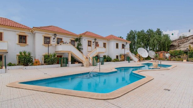 A residential building with a swimming pool, outdoor stairs, and satellite dishes. - Terrace View Studio (Costa Adeje)