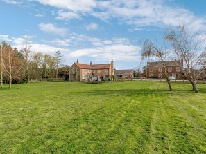 A large, open grassy field with a brick house in the background. - 3 bedroom accommodation in York (York)