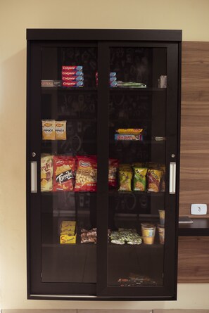 A vending machine stocked with snacks and beverages.