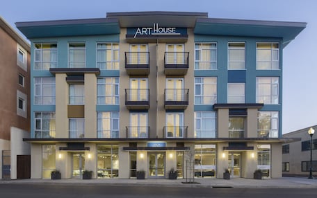 A multi-story hotel with a modern facade, balconies, and a prominent entrance.