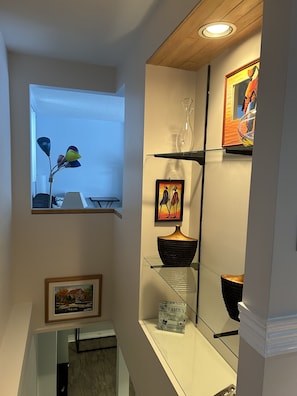 Enjoy a stylish space with a window offering a view of the outdoors, a glass display shelf, and a cozy reading nook.