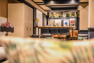 Eine moderne Hotelhalle mit Rezeption, Sitzgelegenheiten und Zierpflanzen.