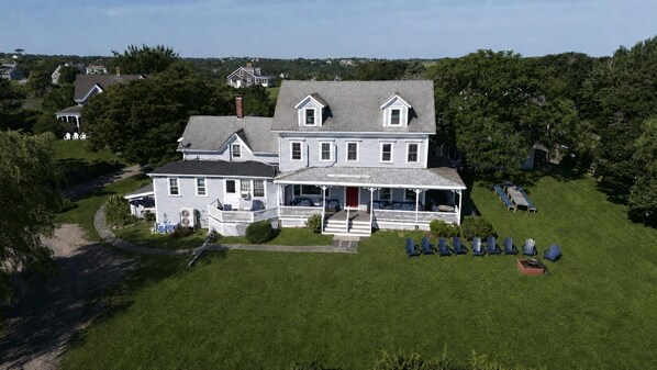 A large two-story house with a porch and outdoor seating area. - WALK FROM FERRY!!!    WALK TO TOWN !!!   BIKE EVERYWHERE!!! (New Shoreham)