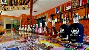 A bar with a colorful, patterned floor and a variety of liquor bottles.