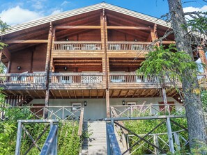 A multi-story wooden building with balconies and a staircase leading to the entrance. - Vacation home  by Interhome (Hyrynsalmi)