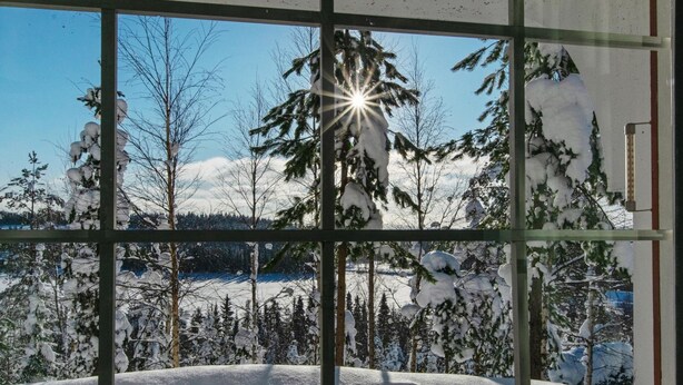 A window view of a snowy landscape with trees and a clear sky. - Alppikylä 13b by Interhome (Hyrynsalmi)