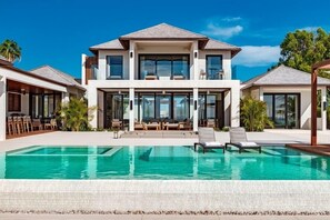 A heated pool, sun loungers