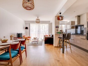 Enjoy meals together at the dining table for four, surrounded by natural light and stylish pendant lights.