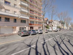 Stylish residential building with balconies and modern architecture.