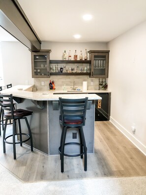 Enjoy cooking in this kitchen with a central island and cabinets.