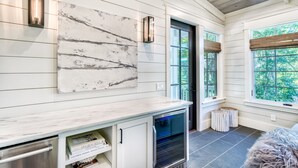 A modern kitchen with white cabinetry, a marble countertop, and a built-in oven. - Luxury 2-Story Home | 2-min to pool | 8-min to the beach | 1-mile from Seaside (Seagrove Beach)