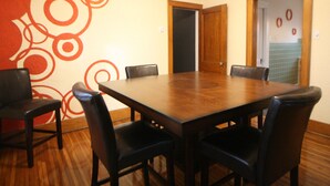 A conference room with a wooden table and black leather chairs. - Safe, Clean & Spacious, Great for Families (Niagara Falls)