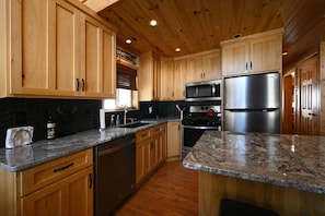 Enjoy cooking in this well-equipped kitchen with a refrigerator, oven, and ample counter space.