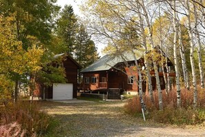 Standalone cabin with a traditional pitched roof and a spacious front porch.