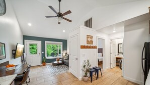 A modern kitchen with a dining area, a ceiling fan, and a view of the outdoors. - GrandLake*Kayak*Forest View*Firepit*King*Lakefront (Grove)
