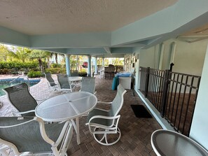 Dining area by pool - 2 tables each with 4 seats