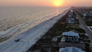 A coastal hotel with a beach view, a road adjacent to the property, and a clear sky. - ECDI | PCB Near 30-A 5BR 4BA Pool Hot Tub EV Charger Early Booking Discounts (Panama City Beach)