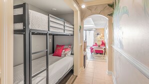A room with bunk beds, a desk, and a chair. - 2nd Floor @ THE SUMMIT 1BR 1.5 BA  Free Beach Chairs!  $240 Weekly Value (Panama City Beach)