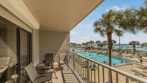 A balcony with a pool view, outdoor seating, and palm trees. - 2nd Floor @ THE SUMMIT 1BR 1.5 BA  Free Beach Chairs!  $240 Weekly Value (Panama City Beach)
