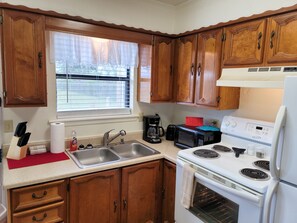 Fridge, microwave, oven, stovetop - Charming 2 Bedroom Duplex Cottage with All Amenities (Idabel)