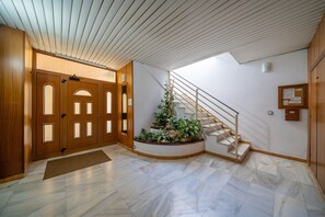 Staircase leads to an upper level with a white railing.