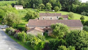 A rural property with a main house and a smaller building, surrounded by lush greenery and a paved road. - La Maison d'Aum -Perigord Dordogne between Bergerac and Perigueux- 8pers-Pool (Bourrou)